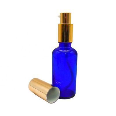stocked round custom 50ml blue glass lotion bottle with gold spray pump for essential oil 