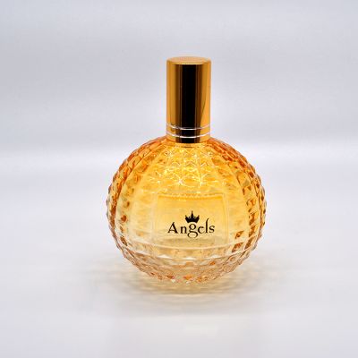Hot sale 100ml light yellow transparent round glass perfume spray bottle with gold cover 