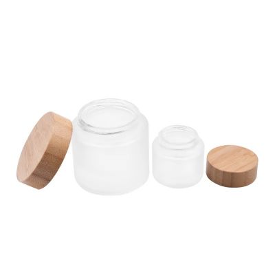 Wholesale 35ml 100ML Frosted Round herb flower plant glass bottles with bamboo screw child resistance lids