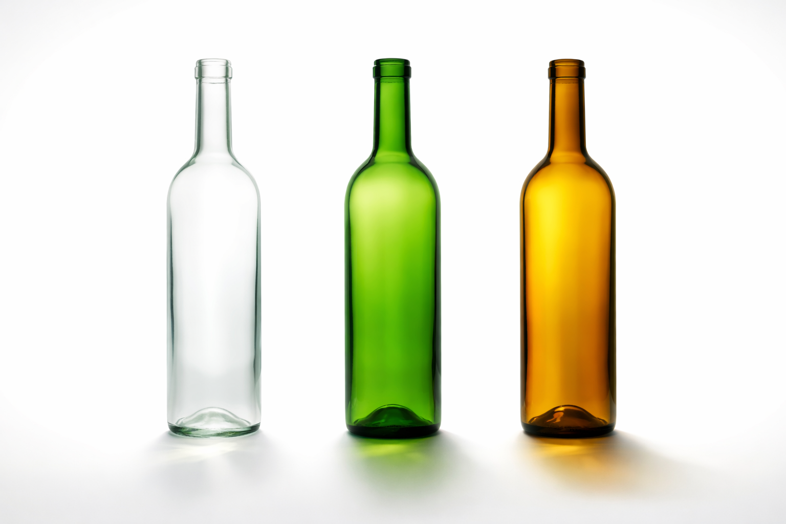 Comparison of clear, green, and amber glass wine bottles under light exposure.