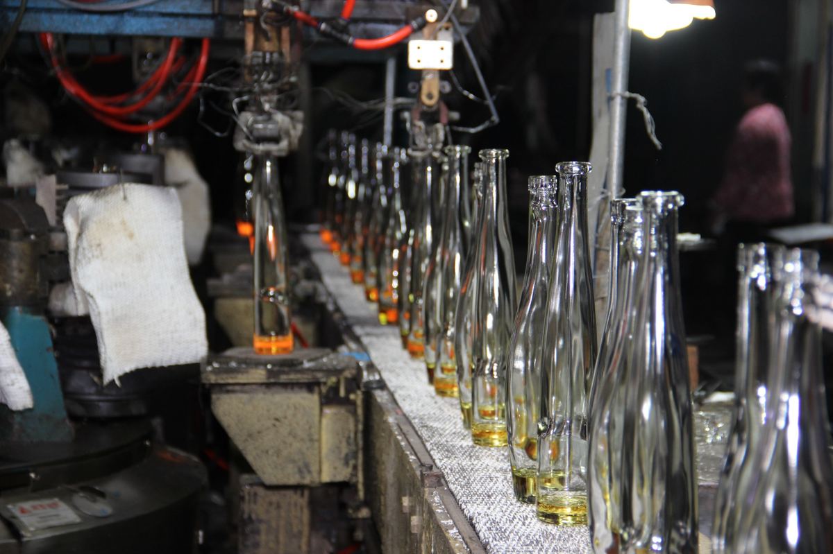 Glass bottles on an automated production line for bulk supply to spirits and wine filling plants