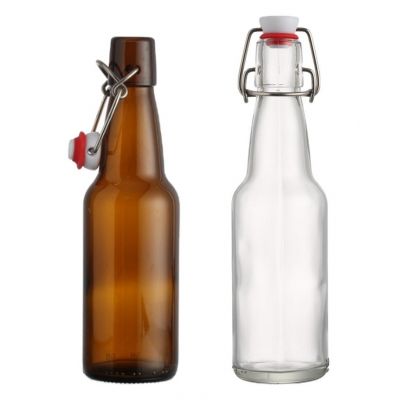 Stocked long neck 300 ml transparent amber empty glass beer bottle with swing lid