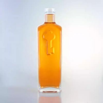 Unique Shape Embossed Key Logo Glass Whiskey Bottle Customized 700ml Bottles For Wholesale
