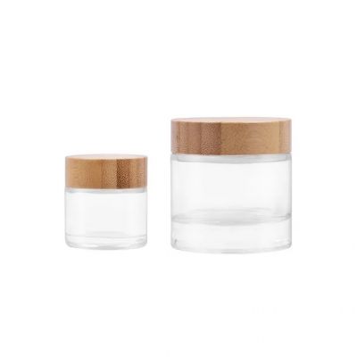 Wholesale 35ml 100 ml clear Round herb flower plant glass bottles with screw child resistance lids