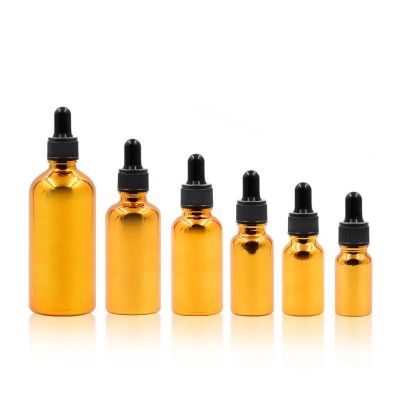 Hot sell 10ml 15ml 20ml 30ml 50ml 100ml empty gold essential oil glass bottle with dropper