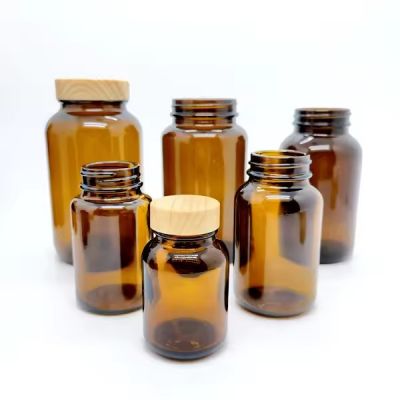 Amber Capsule Glass Pill Bottles 60cc 75cc 100cc 120cc 150cc 200cc 250cc 300cc 400cc 500cc glass packer bottles with bamboo cap