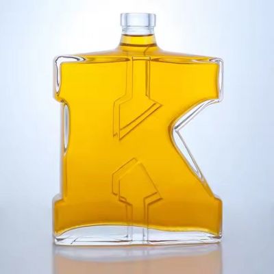 Customized engraved glass bottles 750ml irregular shape glass bottle vodka whisky tequila glass bottle with cork top