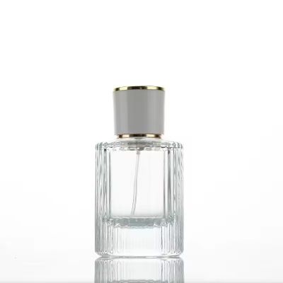 OEM Transparent 30ml 50ml Empty Round Goods in Stock Embossment Glass Perfume Bottle with Pump Sprayer